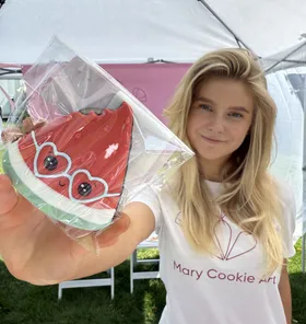 Mary holding a hand-painted watermelon cookie