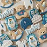 Polo-inspired baby shower cookie set in blue and white with teddy bears, rocking horses, a crib, polo-player onesies, and a baby cap with the polo pony logo.